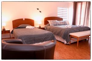 En eller flere senge i et værelse på Hostal Los Teros