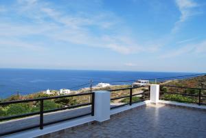 a balcony with a view of the ocean at BAY VIEW HOUSE in Megas Gialos - Nites