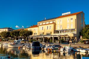 a group of boats are docked in a marina at Hotel Adria in Malinska