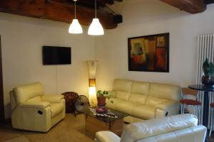 a living room with a couch and chairs and a table at Agriturismo Molino Nuovo in Castel San Pietro Terme