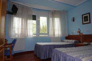 Posteľ alebo postele v izbe v ubytovaní Hostal Campus