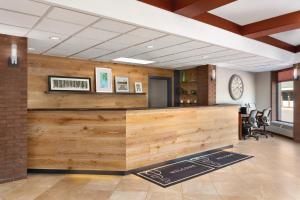 a lobby with a wooden bar in a building at Country Inn & Suites by Radisson, Traverse City, MI in Traverse City +45 photos