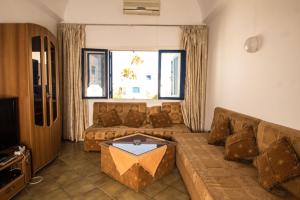 a living room with a couch and a table at Marina Monastir in Monastir