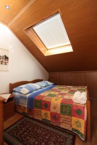 a bedroom with a bed and a skylight at Split Apartments Peric in Split