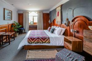 a bedroom with a large bed with a wooden headboard at Selina Cuenca in Cuenca