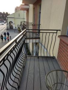 a balcony of a building with people walking down the street at Apartament Kamea Wieliczka Centrum in Wieliczka