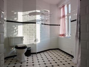 a white bathroom with a toilet and a window at MillasVilla in Lund