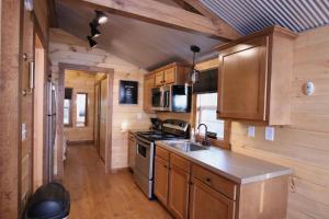 a kitchen with a sink and a stove at The Cayo Cabin, Millersburg Ohio in Millersburg
