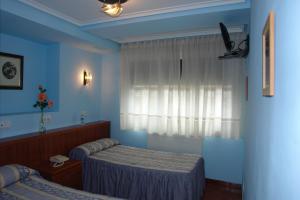 Posteľ alebo postele v izbe v ubytovaní Hostal Campus
