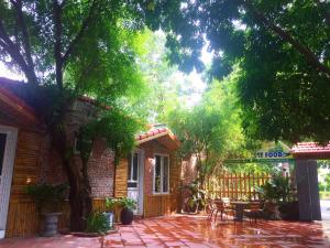 a brick house with a patio with a table and chairs at Tam Coc Green Fields Homestay in Ninh Binh