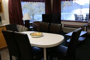 a white table and chairs with a bowl on it at Slumber Lodge in Penticton