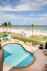 a swimming pool with a view of the beach at Windjammer Resort and Beach Club in Fort Lauderdale