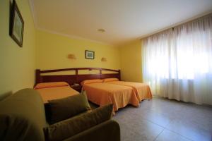 Łóżko lub łóżka w pokoju w obiekcie Hotel La Costera