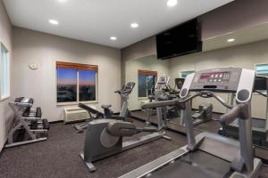 a gym with tread machines and a flat screen tv at Wingate by Wyndham Moses Lake in Moses Lake