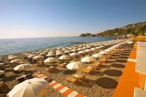 a long line of umbrellas on a beach at Hotel Caparena in Taormina