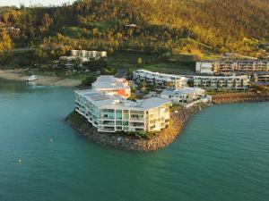 an aerial view of a resort on a island in the water at Peninsula Airlie Beach in Airlie Beach