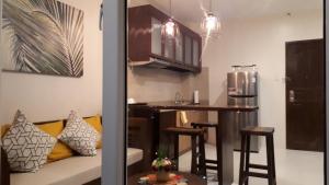 a kitchen with a couch and a bar in a room at JRMPT Residence in Cebu City