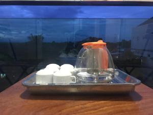 a glass jar on a tray on a table at QUEEN HOTEL Khách sạn QUEEN in Ngọc Tĩnh