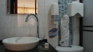 a bathroom with a sink and a toilet at Hotel Sipa in Duitama