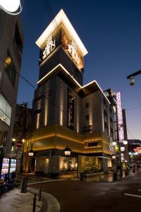 a tall building with a clock on top of it at Hotel Sen (Adult Only) in Osaka