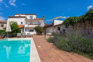 a house with a swimming pool in front of a house at Casa Kujici in Krnica