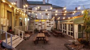 a patio with picnic tables and string lights at Orbost Club Hotel in Orbost
