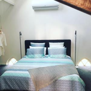 a bedroom with a bed with blue and white pillows at St James Converted Church in Miners Rest