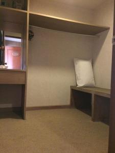 a room with a shelf with a pillow on it at Pin Hotel in Lampang