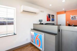 a kitchen with an orange and white wall at Motel 6-Odessa, TX - 2nd Street in Odessa