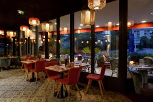 a restaurant with tables and chairs and windows at Best Western Montecristo-Bastia in Bastia