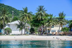 einen Strand mit Palmen und Menschen im Wasser in der Unterkunft Ananda Villa - SHA Plus in Ko Tao