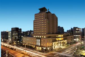 a tall building in a city at night at Hotel Mielparque Nagoya in Nagoya