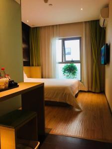 a hotel room with a bed and a window at IU Hotel Beijing Life Science Park Station in Changping +22 photos