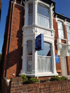 a house with a blue sign in front of it at Everley Guest House in Portsmouth