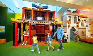 a group of people playing with a toy house at LEGOLAND Japan Hotel in Nagoya