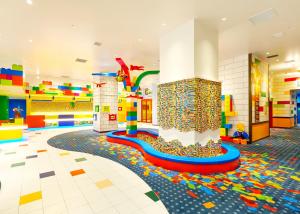 a large room with a play area with a colorful floor at LEGOLAND Japan Hotel in Nagoya