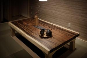 a wooden table with two candles on top of it at Bijou Suites Will in Osaka