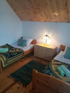 Postel nebo postele na pokoji v ubytování Apartments And Rooms Gold