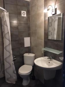 a bathroom with a toilet and a sink at The White Houses Complex in Nesebar