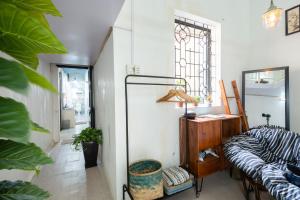 a living room with a couch and a mirror at Old Quarter Apartment Hang Bo in Hanoi