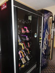 a vending machine with many different types of drinks on it at Columbus Inn in Columbus