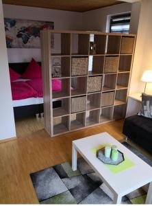 a living room with a bed and a room with a table at Apartment Ferienwohnung Emmerthal auch für Monteure FeWo in Emmerthal