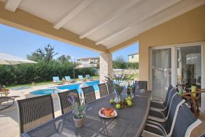 a table with a bowl of fruit on it on a patio at Villa 1520 in Žminj