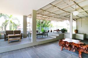 a living room with a table and some chairs at RedDoorz near UPI Setiabudi 2 in Bandung