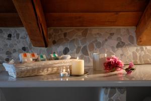 a counter with two candles and a basket with flowers at Mistral Hotel in Hydra