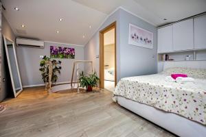 a bedroom with a large bed and a bathroom at Apartments Babo in Rovinj