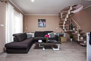 a living room with a couch and a staircase at Apartments Babo in Rovinj +72 photos