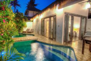 a swimming pool in the backyard of a house at Atoll Haven Villas in Gili Islands