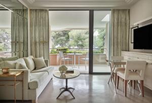 a living room with a couch and a table at Grand-Hôtel du Cap-Ferrat, A Four Seasons Hotel in Saint-Jean-Cap-Ferrat