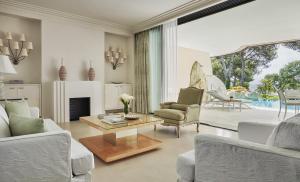 a living room with a couch and a table at Grand-Hôtel du Cap-Ferrat, A Four Seasons Hotel in Saint-Jean-Cap-Ferrat